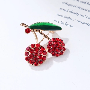 Elegant cherry brooch with red rhinestones and green enamel leaf on a gold-plated stem