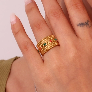Detailed close-up of a wide 18K gold-plated stainless steel ring with colorful gems