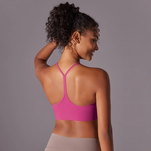 Close-up back view of rose pink racerback sports bra with cutout strap details