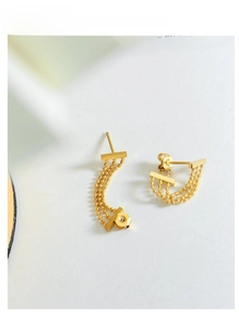 Detail of 18K gold-plated triple bead chain tassel earrings with smooth metallic finish