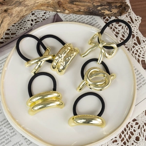 Set of 6 minimalist black elastic hair ties with diverse golden metal geometric charms