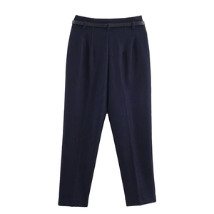 Detail of high waist dark blue trousers with a slim black belt and formal pleated design