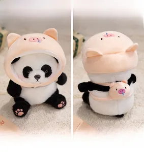 Detail view of plush panda toy wearing a pink pig hoodie and matching backpack accessory