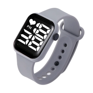 Macro detail of square LED watch with grey silicone strap and digital time display