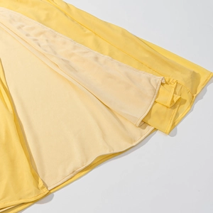 Detail shot of yellow slit dress showing double-layer chiffon fabric and neat hemline