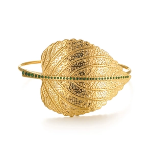 Gold leaf bangle bracelet featuring green crystals on a sleek stainless steel band