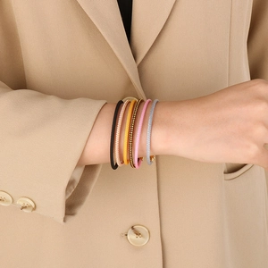 Close-up of a six-piece set of woven mesh stackable bracelets in multi-color finishes