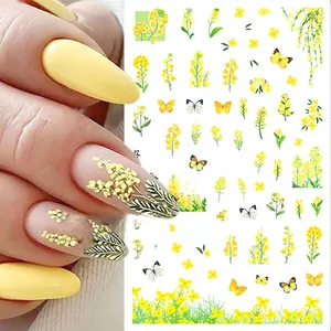 Detail of yellow flower and butterfly nail stickers on model hands and product sheet
