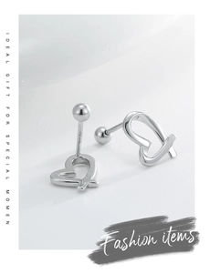 Macro shot of S925 sterling silver heart earrings with visible authenticity hallmark