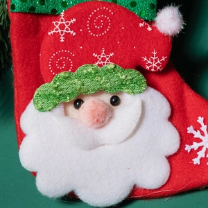Sparkly Christmas stocking with Santa Claus character, green sequins and snowflake pattern