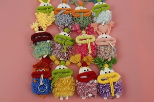 Detail showing various colorful hand-crocheted monster keycovers with sturdy metal rings