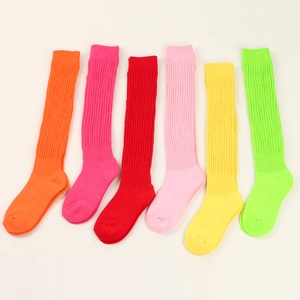 Flat lay of colorful ribbed knit slouch socks in orange, pink, red and yellow shades