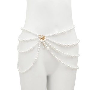 Detail of layered white pearl waist chain with golden metal clasp on female torso