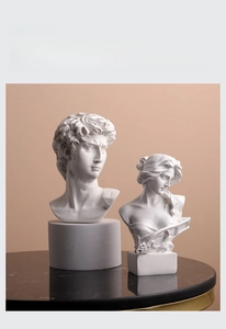 Detail of David and lady bust statues in white resin on elegant marble pedestal