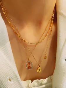 Detailed close-up of a three-layer gold necklace with Pingan character and gourd charm
