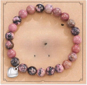 Detail of pink and black spotted bead bracelet with heart charm on gift message card