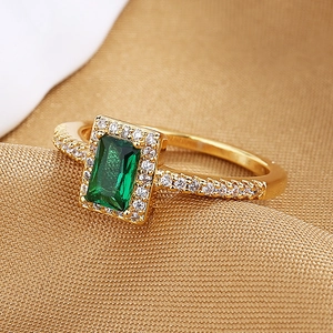 Luxury emerald cut green zircon ring in gold finish with sparkling pavé crystals