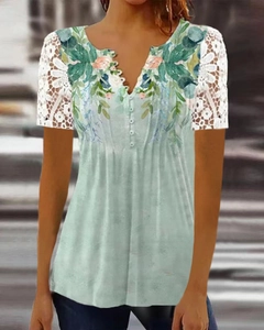 Short sleeve floral top in light green featuring white lace sleeves and V-neckline