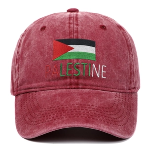Detail of embroidered Palestine flag and lettering on a burgundy washed cotton baseball cap