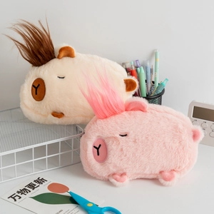 Fuzzy Capybara plush pencil cases in pink and beige colors with colorful hair on a desk