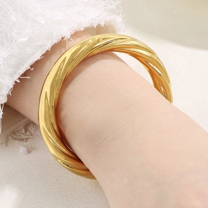 Close-up of 18K gold plated stainless steel twisted rope bracelet on woman wrist