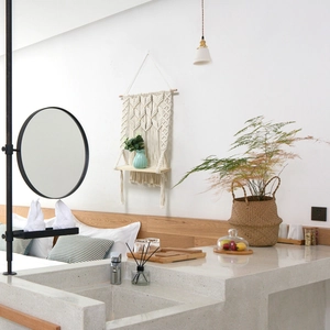 Detail of macrame wall hanging shelf with a wooden board in a modern bathroom decor
