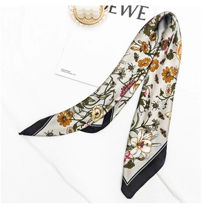 Close-up of vintage floral print twilly silk scarf with bee and beetle patterns