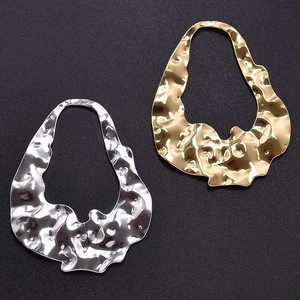 Detailed macro view of gold and silver hammered 304 stainless steel pendants