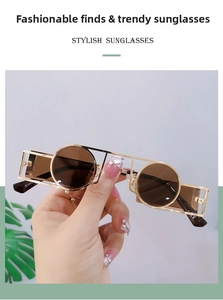 Detail of round punk sunglasses with gold geometric metal frames and tinted lenses