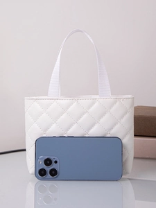 Front view of small white quilted handbag with smartphone for size comparison on mirror surface