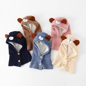 Detail view of five knit baby bear hats with warm fleece lining and wooden buttons