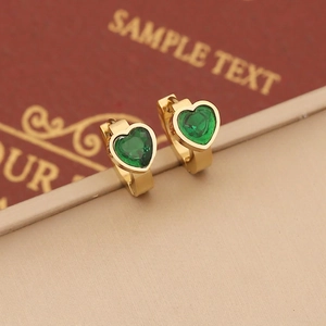 Close-up of heart-shaped emerald green crystal earrings with golden huggie hoop design