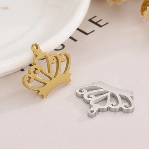 Detailed view of crown-shaped DIY necklace pendants in gold and silver finish