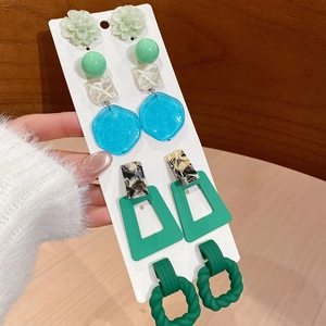 Detail view of colorful acrylic earring set with geometric floral and resin designs