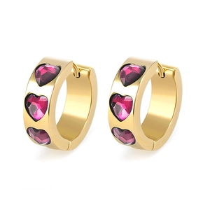 Macro shot of 18k gold heart hoop earrings with three purple cubic zirconia stones