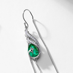 Elegant silver peacock drop earrings with emerald green stone and sparkling diamonds