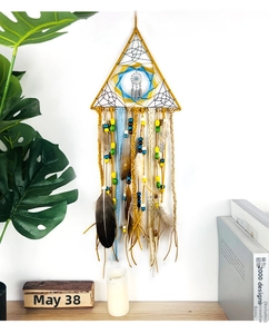 Detailed view of handmade triangular dream catcher with vibrant feathers and wood beads