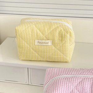 Cute candy striped quilted makeup bags in yellow and pink with embroidered logo