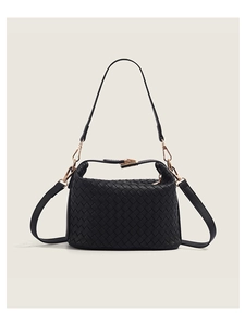 Detail of black woven leather shoulder bag with gold hardware and dual strap system