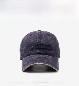 Detail of vintage washed navy baseball cap with GUHHA embroidered patch and distressed texture