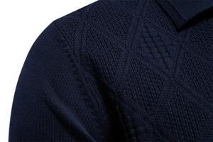 Macro shot of dark blue knit fabric texture and shoulder stitching detail on men sweater