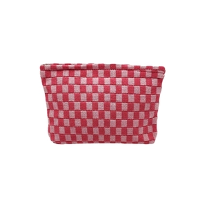 Knitted checkerboard makeup bag in red and pink pattern with spacious interior