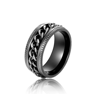 Macro detail of black rotating cuban chain ring with industrial brushed metal texture