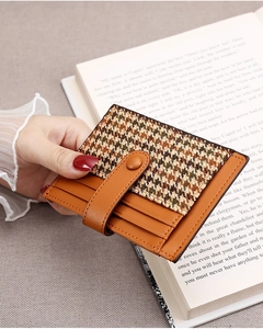 Detail of slim houndstooth card holder with snap button closure and multiple card slots