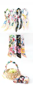 Close-up of four floral silk scarves in yellow, white, black and pink with abstract patterns