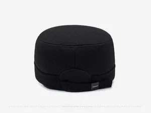 Rear view of black wool flat top cap featuring adjustable strap and branded label