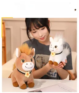 Close-up of cute plush horse dolls with fluffy manes and crochet collars held by a model
