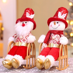 Detail of Christmas plush doll with red sequins and festive velvet outfit on rocking chair