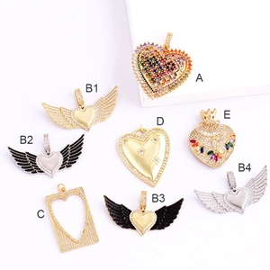 Close-up of gold plated micro-pave heart and wing charms for DIY jewelry making