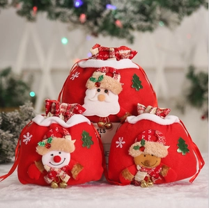 Three plush Christmas drawstring gift bags featuring Santa, snowman, and reindeer designs